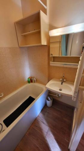 une salle de bain avec une baignoire et un lavabo dans l'établissement Appartement d'angle , les Issarts, à Superdevoluy