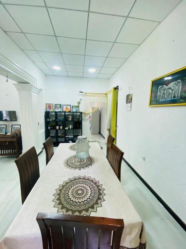 a dining room with a table and some chairs at Suriya Homestay in Badalgama
