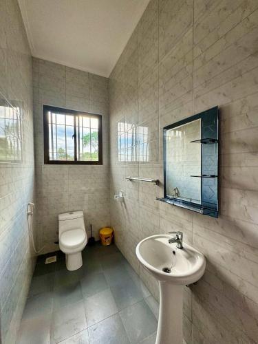 a bathroom with a toilet and a sink at Moshono Hillside in Arusha