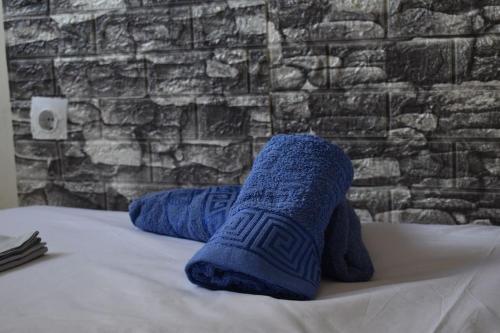 a pair of blue socks sitting on a bed at Villa Vitta picola casa in Nafpaktos