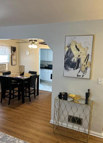 a dining room and living room with a table and chairs at Cozy Apartment 6 miles from Downtown, Cincinnati in Cincinnati
