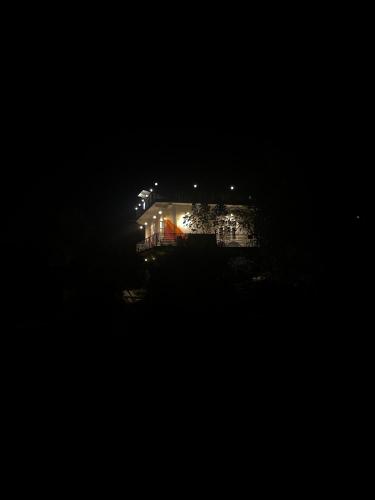 a house at night with lights in the dark at Akaasa homes in Baijnāth