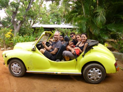 a group of people riding in a yellow car at The Nilmini Lodge in Sigiriya