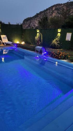 a swimming pool at night with a blue illumination at mutlu ve huzur dolu bir tatil in Ortaca