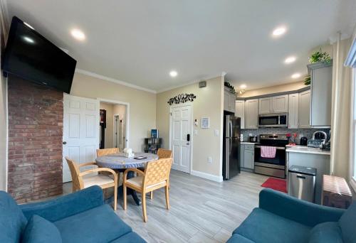 a living room with a blue couch and a table at New York City Apartment Near Free Ferry Boat! in Stapleton
