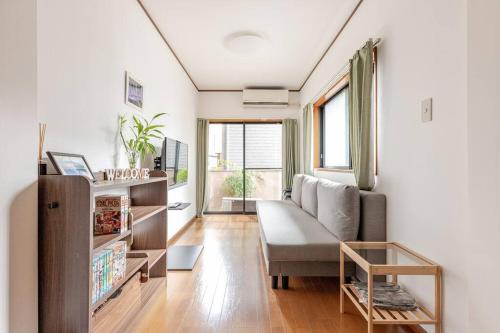 a living room with a couch and a chair at kensui house in Tokyo