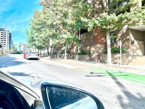 a car is driving down a city street at Beautiful Uptown Adventure Apartment in Charlotte