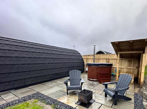 two chairs and a table on a patio at Fernhill Valley Farm in Blaencwm