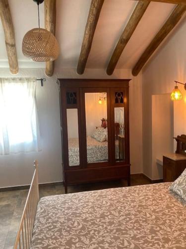 a bedroom with a bed and a large mirror at Casa do Monte T2 - Esperança in Arronches