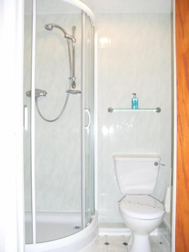 a bathroom with a shower and a toilet at The Pebbles - Adults Only in Weymouth