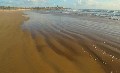 a beach with waves coming in from the ocean at Al Borgo dell'Arte Suite in Scicli