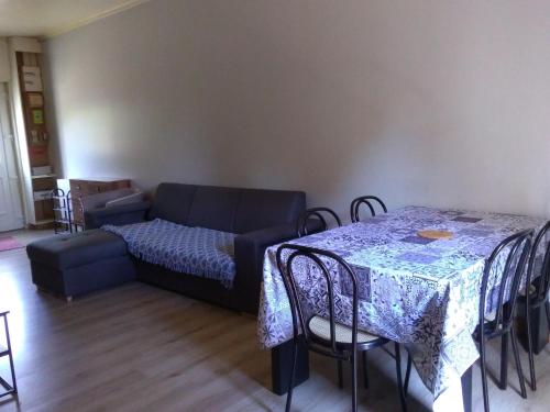 un salon avec un canapé, une table et des chaises dans l'établissement Maison de ville - proche Le Pal - Dompierre, à Dompierre-sur-Besbre