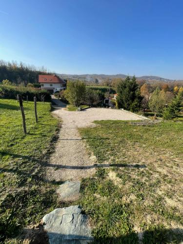 a stone path in a field with a house in the background at Kőlépcsős Vendégház in Nyúl