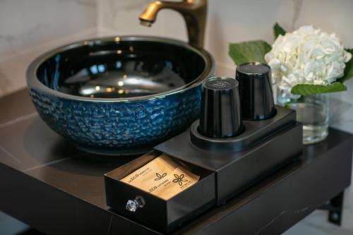 a black counter with a blue bowl on a table at Phat Diem Plaza Hotel in Ninh Binh