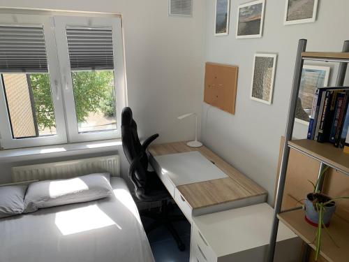 a bedroom with a desk and a bed and a desk at 2 bed Cozy Home Lusk - 15min from Dublin airport! in Lusk