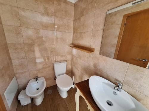 a bathroom with a sink and a toilet and a sink at Casa das conchas in Buarcos