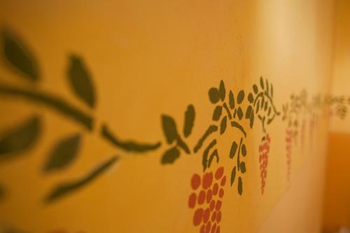 a wall with green leaves painted on it at Mas Montluzia in Cascastel-des-Corbières