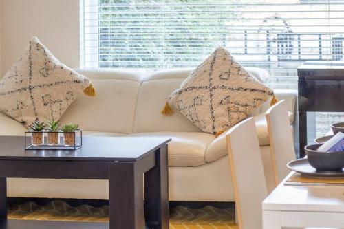 a living room with a white couch and a table at Lena House in Glasgow