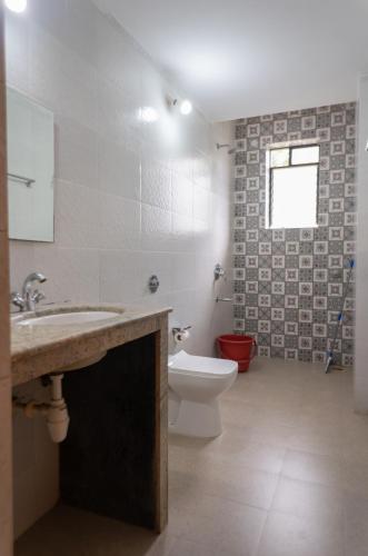 a bathroom with a sink and a toilet at 1 BHK Private Apartment in Varca