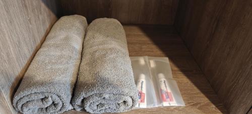 a bathroom with two towels and a sink in a box at Mely’s Tiny Home in Samporo