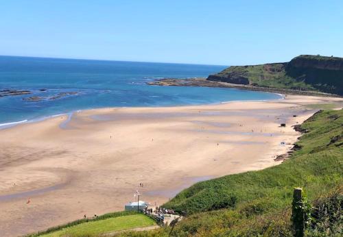 a view of a beach with people on it at Casa Cayton bay in Cayton