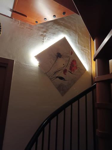a stairwell with a painting on the wall at La Casa di Ciro GC & Friends in Ferno