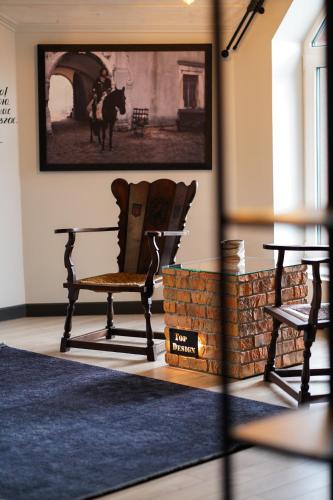 a rocking chair in a room with a picture on the wall at Готель-ресторан Два Леви in Slavske