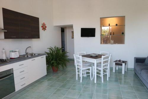 a kitchen and living room with a table and chairs at Il Balcone delle Dee in Agerola