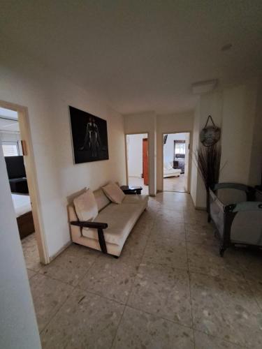 a living room with a couch and a table at הוילה בעומר in ‘Omer