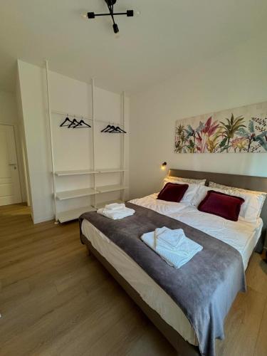 a bedroom with two beds and a painting on the wall at SanLa Home in San Lazzaro di Savena