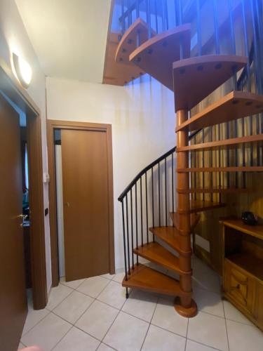 a spiral staircase in a room with a hallway at La Casa di Ciro GC & Friends in Ferno