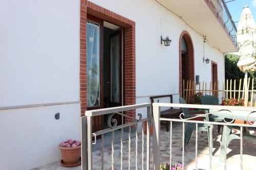 a white house with a balcony with a door at Il Balcone delle Dee in Agerola