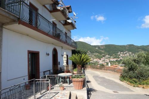 a balcony of a building with a table and plants at Il Balcone delle Dee in Agerola