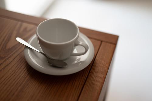 a cup and a spoon on a plate on a table at Il Leccio Verde in Lecce