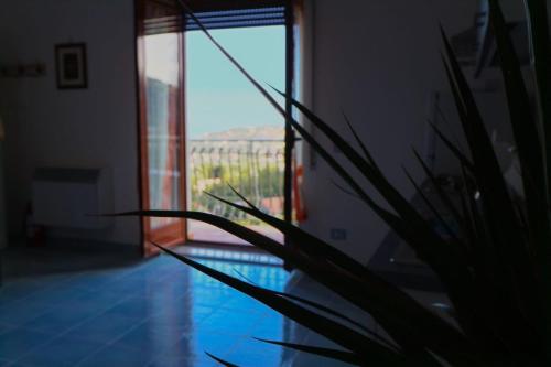 a plant sitting next to a window with a view at Il Balcone delle Dee in Agerola