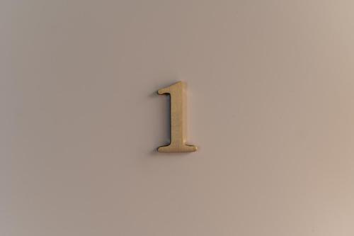a wooden number on a white wall at Il Leccio Verde in Lecce