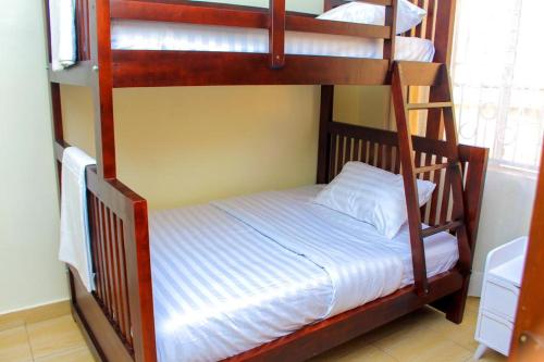 two bunk beds in a room with a bed at POPPI HOUSE 3 bedroom in Kampala