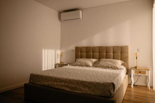 a bedroom with a large bed and two night stands at Portugal Alma Villa Algarve - Luxury Villa with Private Pool in Alcantarilha