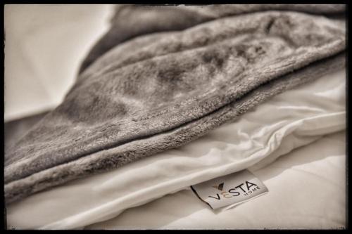 a close up of a towel on a bed at La maisonnette in Árgos Orestikón