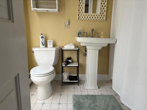 a bathroom with a white toilet and a sink at Modern Cottage Downtown NPT-Waites Wharf Cottage RE05618-STR in Newport