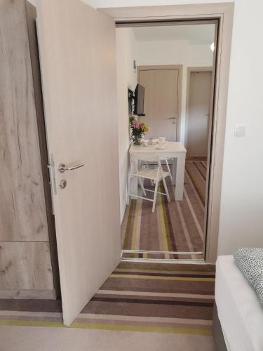 a door leading into a room with a table at Vila Lela in Vrnjačka Banja