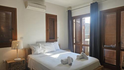 a bedroom with a bed with two slippers on it at STAY Aphrodite Hills Apartment in Kouklia