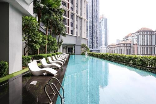 a swimming pool in the middle of a city with buildings at The Mews KLCC by GB in Kuala Lumpur