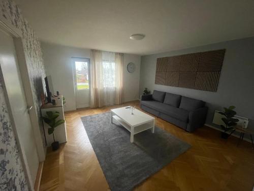 a living room with a couch and a coffee table at Cozy Apartment in Grimsås