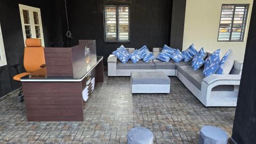 a living room with a couch with blue pillows at W&H View Residency in Cochin