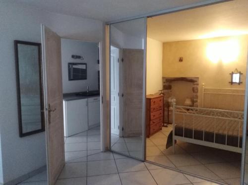 a room with a glass door leading to a bedroom at La musardière in Les Assions