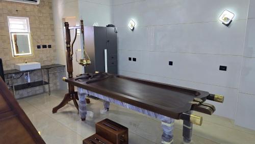 a pool table in a room with a sink at W&H View Residency in Cochin