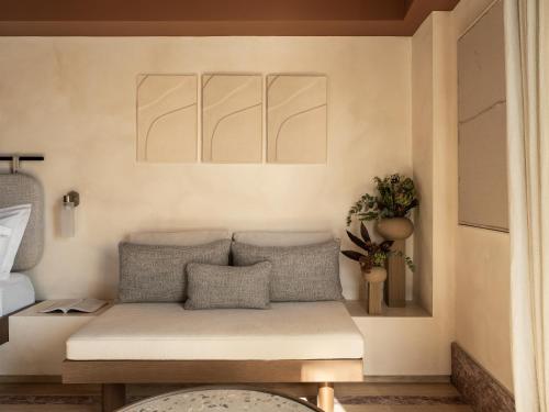 a living room with a couch with pillows on it at Igisó in Ermoupoli