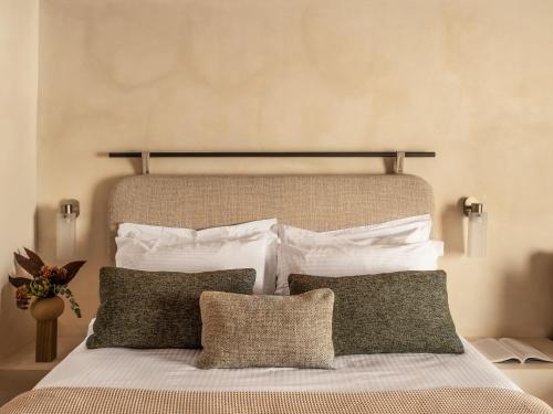 a bedroom with a large bed with white pillows at Igisó in Ermoupoli