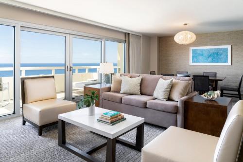 a living room with a couch and a table at Sheraton Waikiki Beach Resort in Honolulu